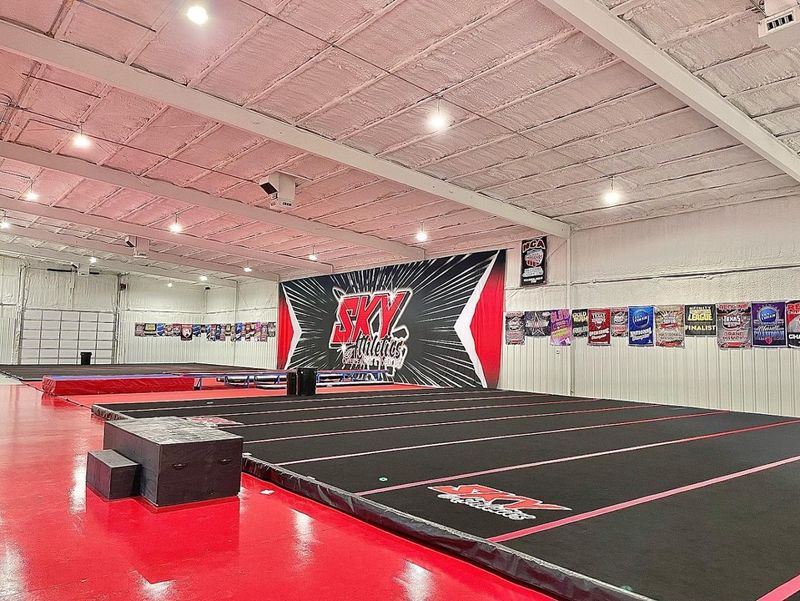 The Sky Athletics gym floor with the red and black SKY wall